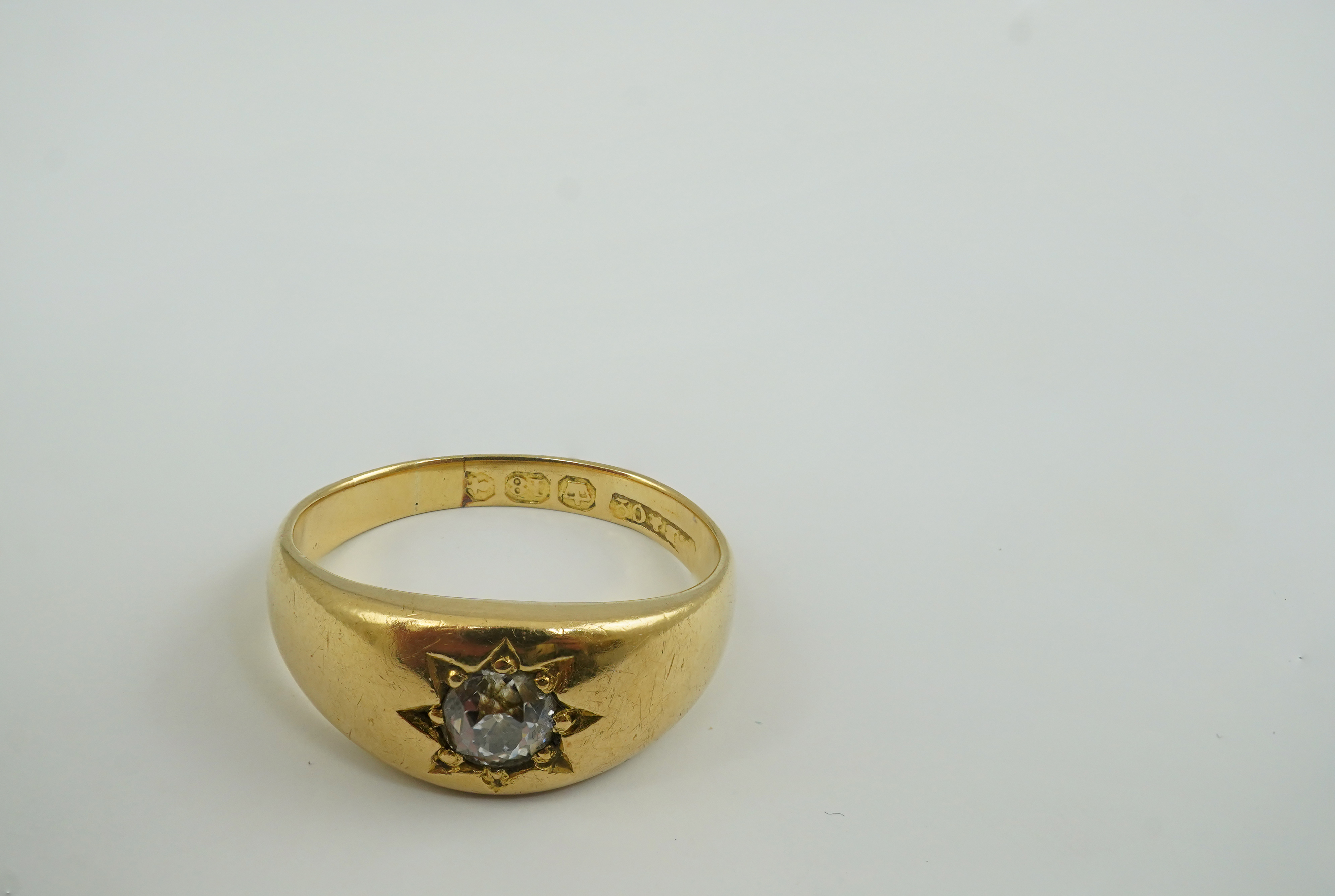 An early 20th century 18ct gold and gypsy set solitaire diamond ring